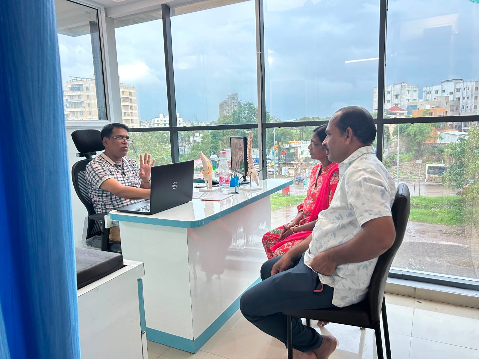 Dr. Pandurang Ramchandra Narale consulting with a patient